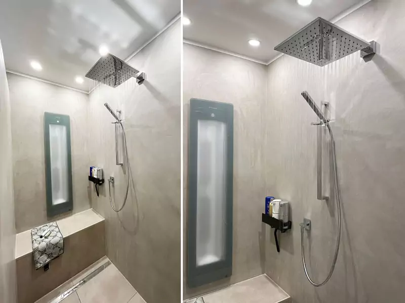 Moderne Walk-in-Dusche mit großer Regendusche, Handbrause und integrierter Infrarot-Heizplatte in einem hochwertigen Designbad.